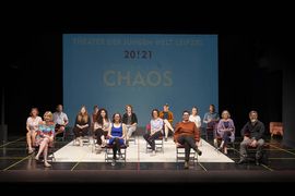 Foto mit B&uuml;hne mit mehreren sitzenden Personen